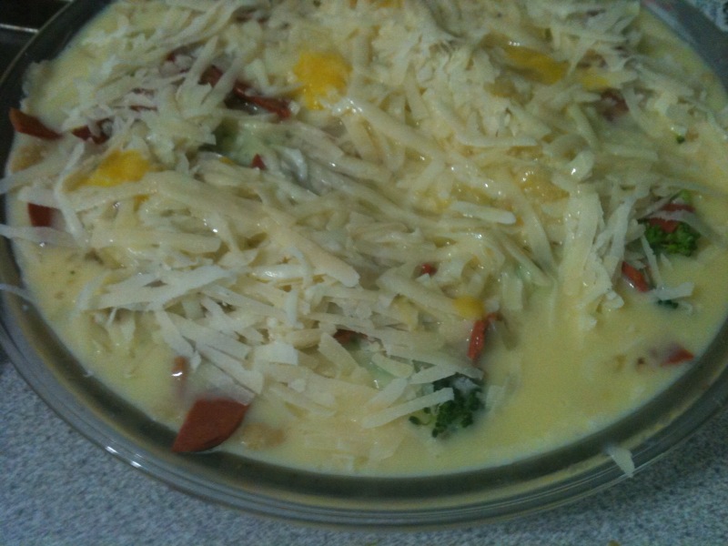 Spread 1 ½ C of grated mozzarella cheese over top of the vegetables. In a separate bowl, combine 4 well beaten eggs and 1 ½ cups of skim milk, whisk together and pour over top of quiche.  