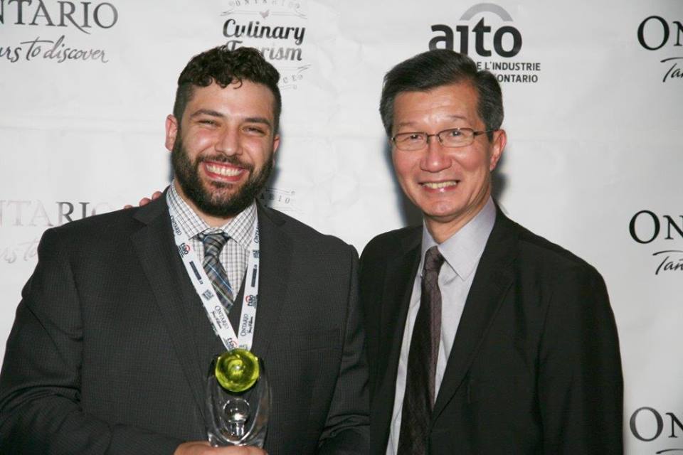Adriano Ciotoli of WindsorEats holding the 2013 Ontario Culinary Tourism Leadership award with Minister of Culture and Tourism, Michael Chan