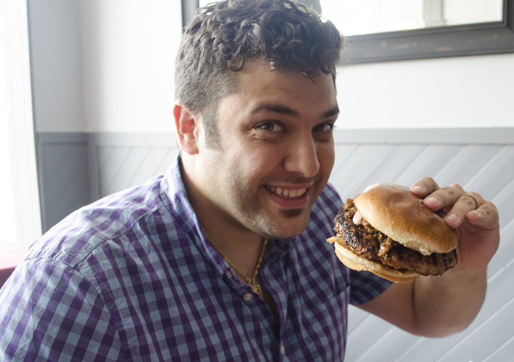 Adriano Ciotoli about to dig into the Turducken Burer at Honey Badger Bistro