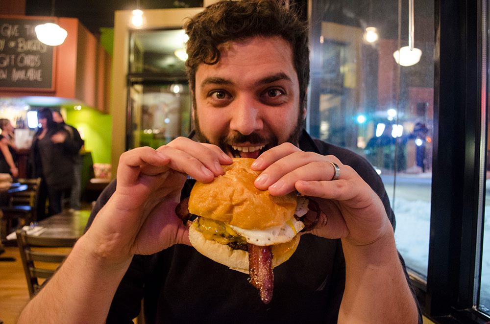 Adriano Ciotoli of WindsorEats is about to chomp into a burger from Mamo Burger