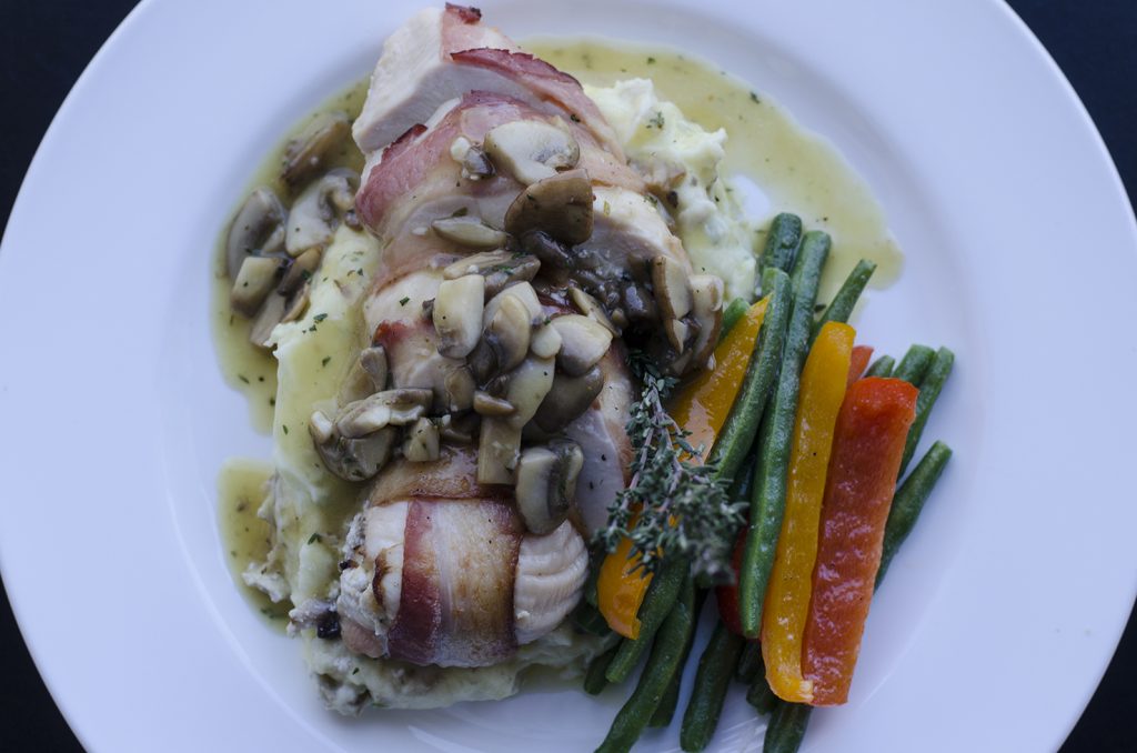Ricotta and mushroom stuffed chicken breast wrapped in bacon.