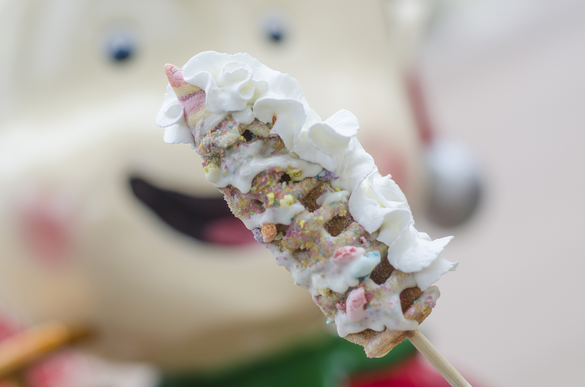 The Unicorn Waffle classic waffle is coated in white chocolate and a fruity magic dust.