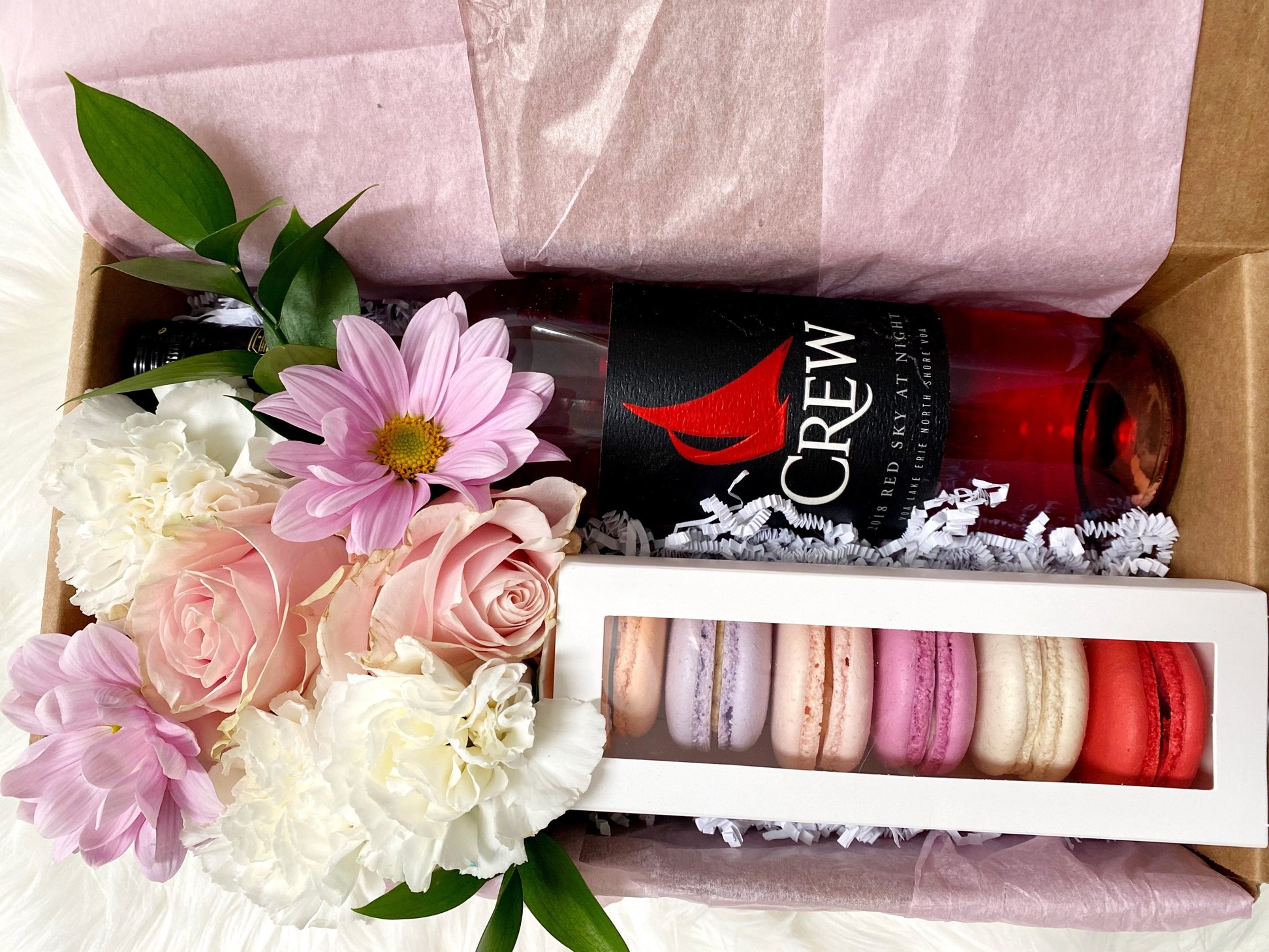 French Macarons bundled with a floral composition and an Ontario-made beverage.